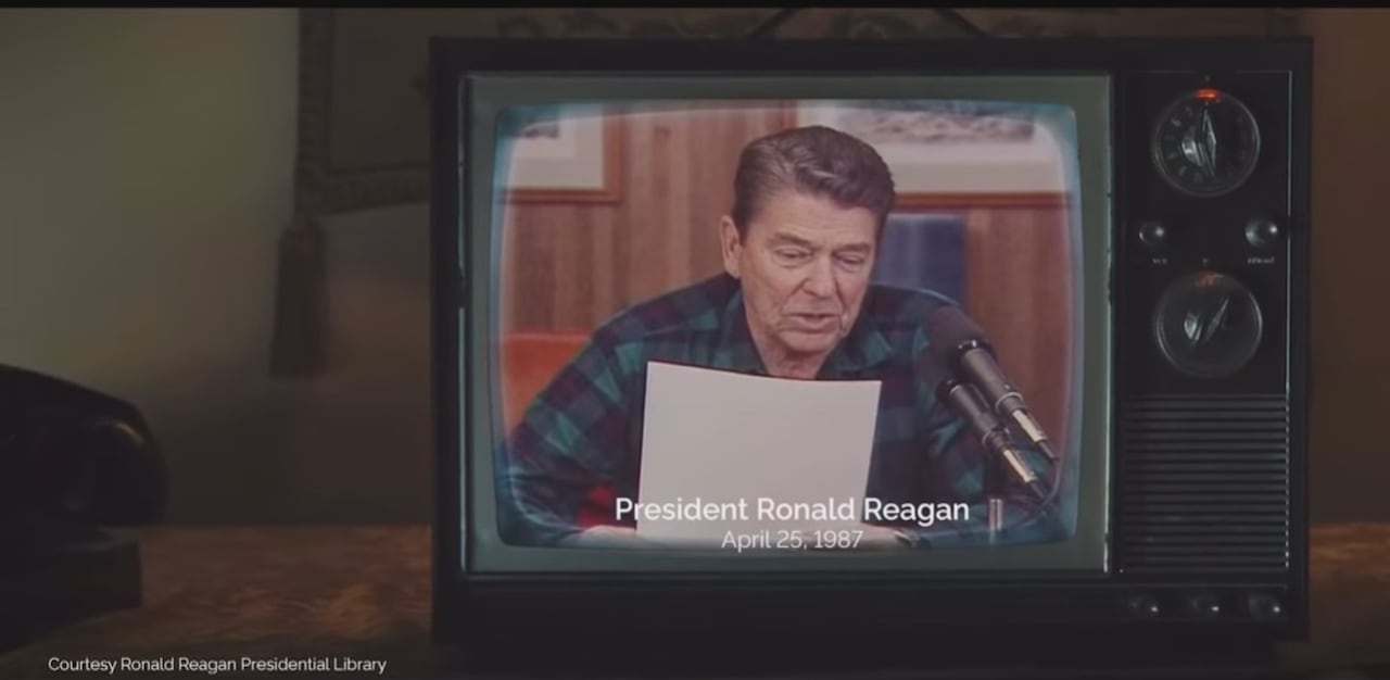 An older television shows an image of Ronald Reagan reading from a script. 