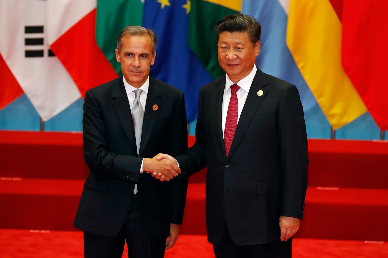 Two men in suits shaking hands.