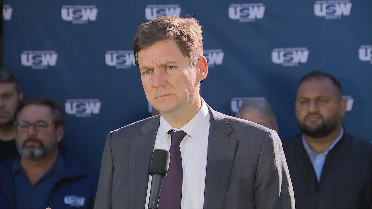 Premier David Eby furrows his brow as he speaks during a press conference.