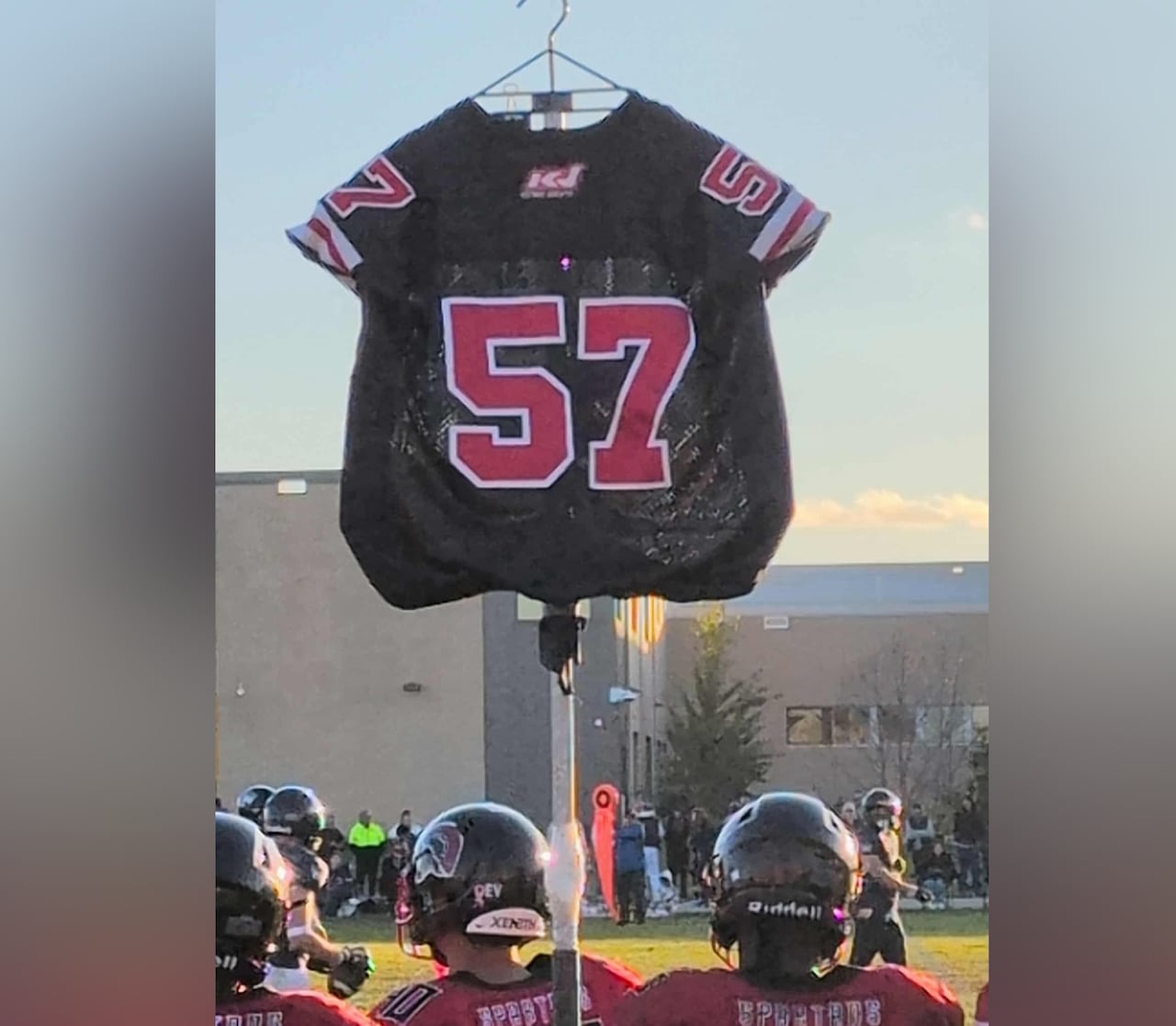 A football jersey is hoisted on a pole