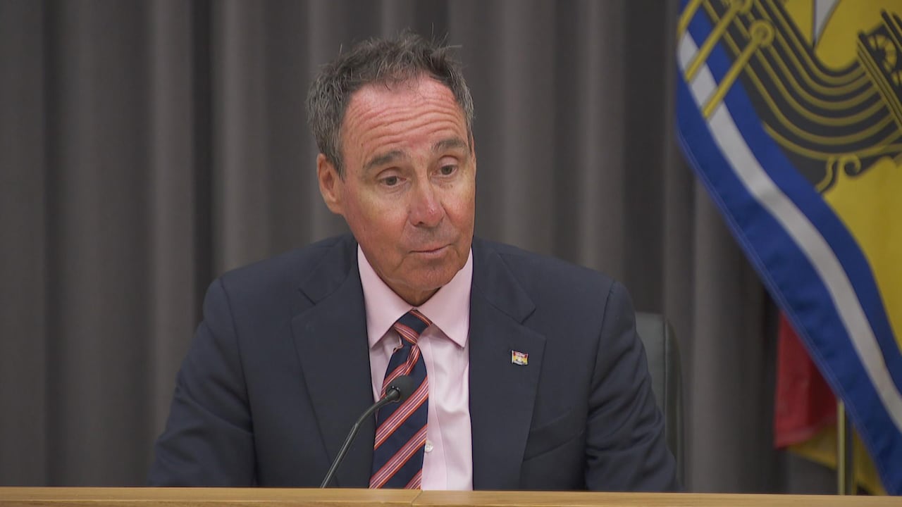 Man in a suit at a podium microphone.