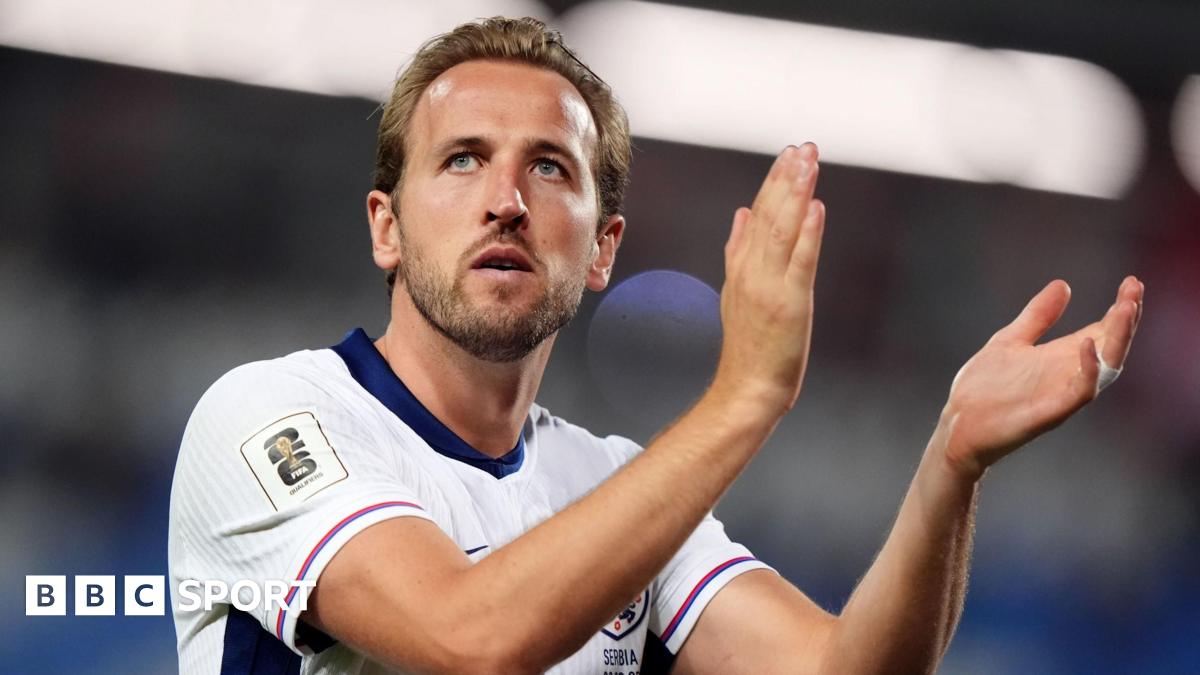 Harry Kane claps while playing for England