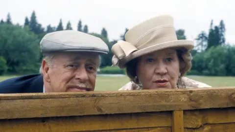 Patricia Routledge as Hyacinth Bucket alongside Clive Swift who played her husband, Richard