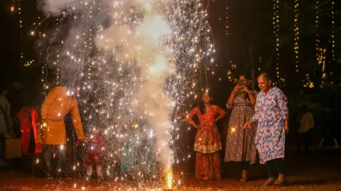 Reuters People light firecrackers on the occasion of the Diwali festival in Mumbai, India, 12 November 2023. Diwali, the Hindu festival of lights, symbolizes the victory of good over evil and commemorates Lord Rama's return to his kingdom, Ayodhya, after completing a 14-year exile.