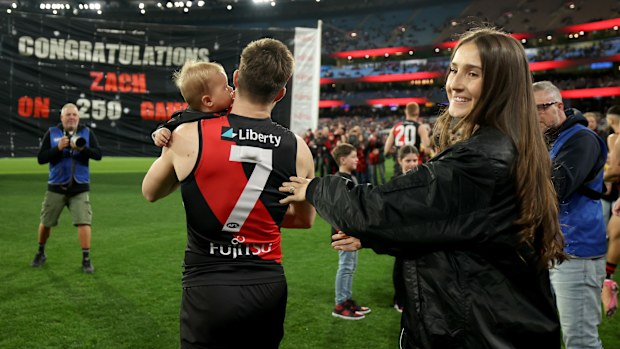 Zach Merrett of the Bombers is congratulated on his 250th game.