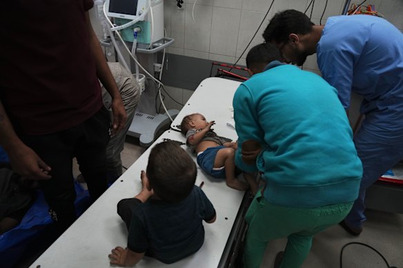 Wounded Palestinian infants are treated at Nasser Hospital in Gaza on Sunday after an Israeli army strike.