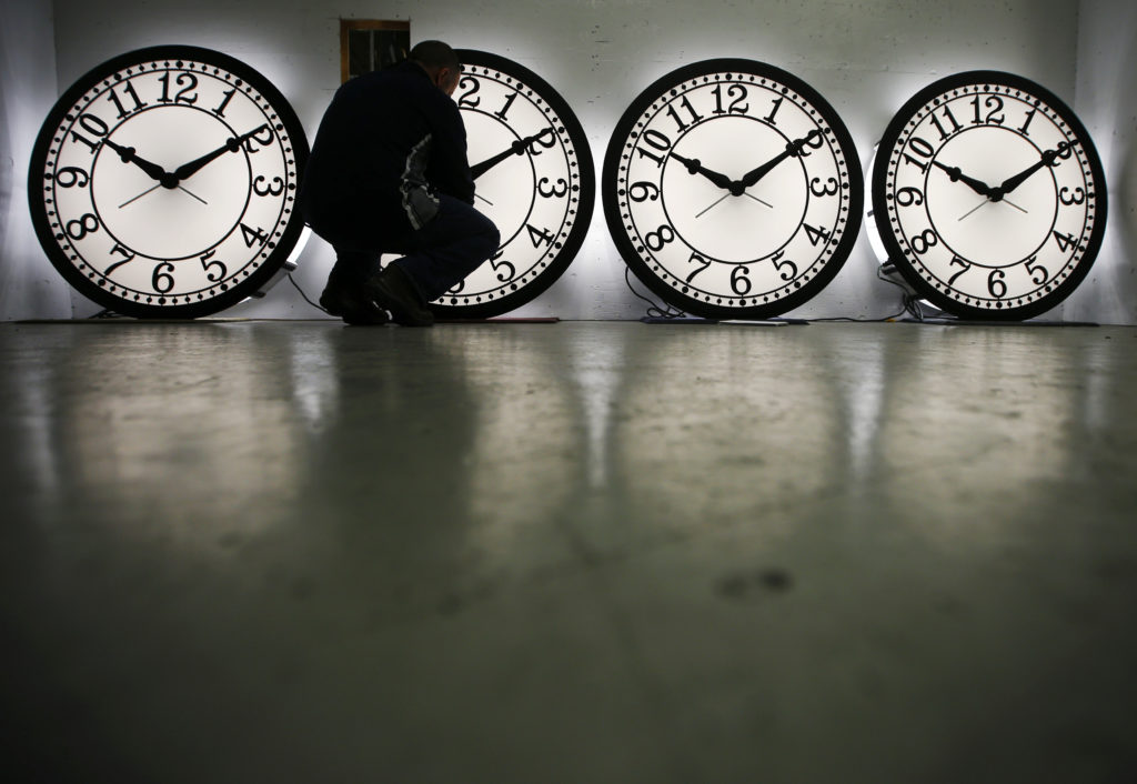 Peter Shugrue checks one of four custom, flush mounted clocks, destined for installation in Kansas City, Missouri, at the ...