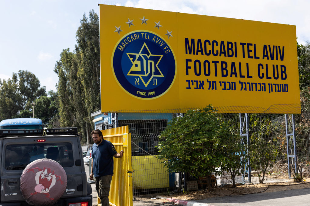 A worker stands outside the training ground of Maccabi Tel Aviv football club in Tel Aviv