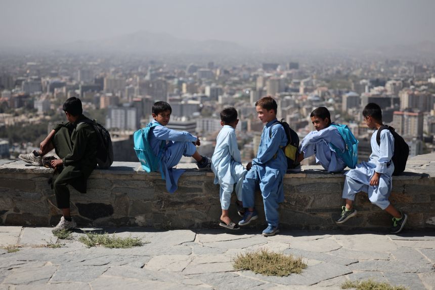 Afghan children sit on a concrete bench at a hilltop, amid telecom shutdown across the country, in Kabul, Afghanistan, on September 30, 2025.