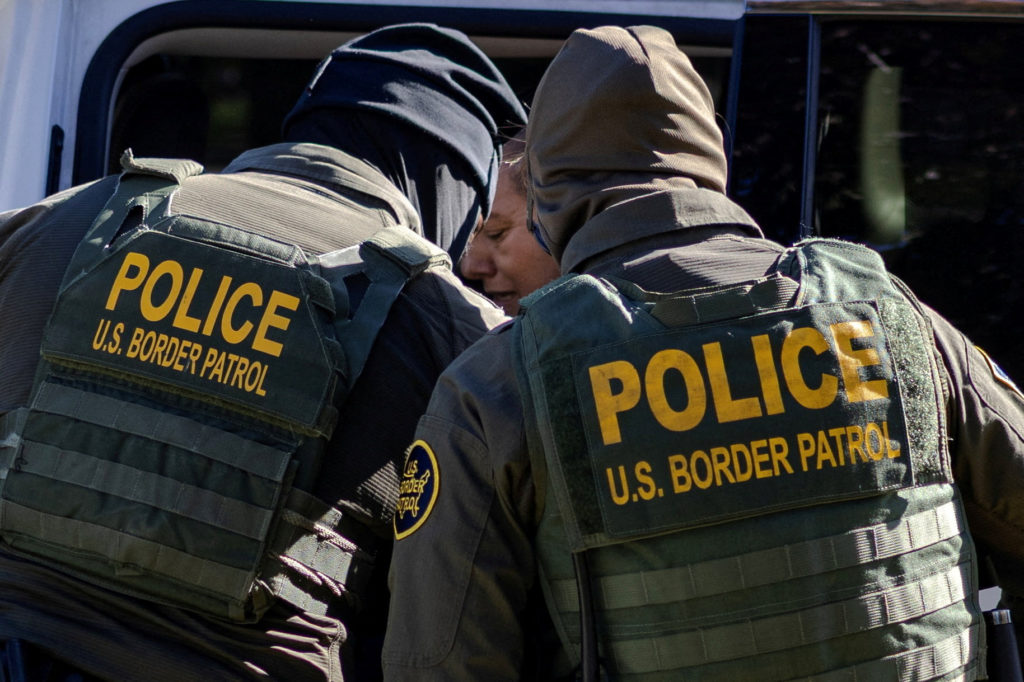 Federal agents detain several people during an immigration raid in Chicago