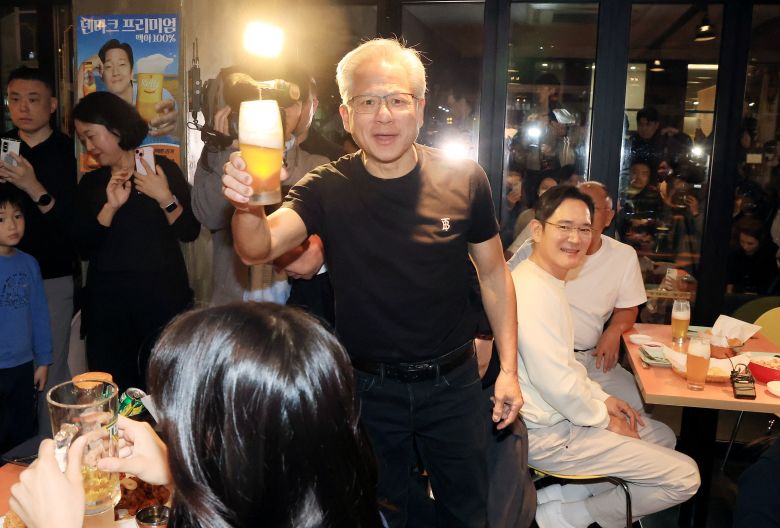 Nvidia CEO Jensen Huang makes a toast with others during a dinner meeting with Samsung Electronics Chairman Jay Y. Lee and Hyundai Motor Group Executive Chair Euisun Chung at a fried chicken restaurant in Seoul, South Korea, on October 30, 2025.