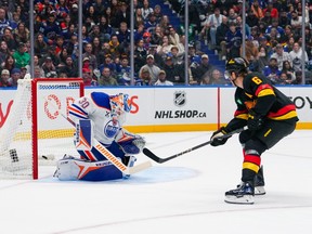 Brock Boeser scores a goal on Calvin Pickard during the first period at Rogers Arena on Sunday night.