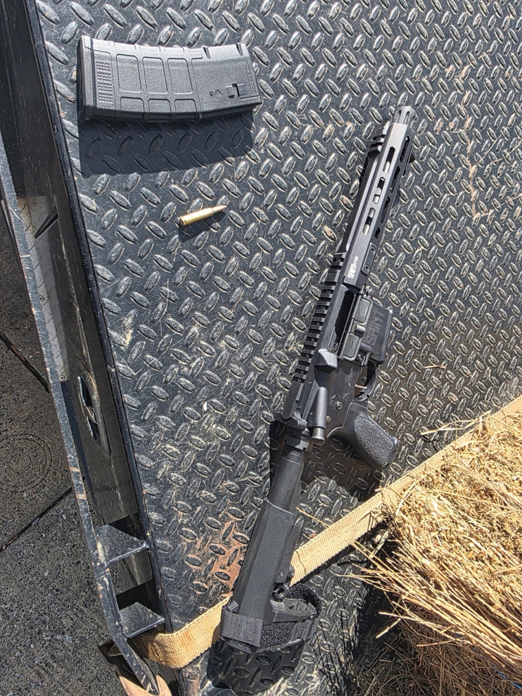 A gun and ammunition seen on a surface outside
