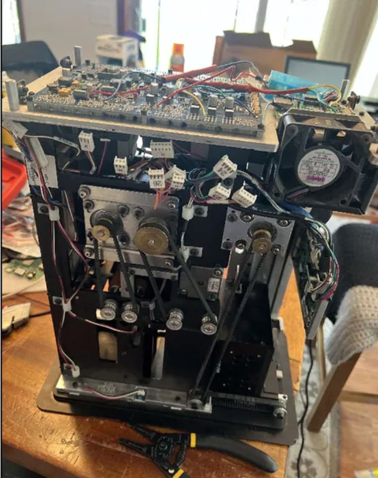 Image of a DeckMate 2 shuffler taken apart on a table, from defendant Shane Hennen's iCloud account.