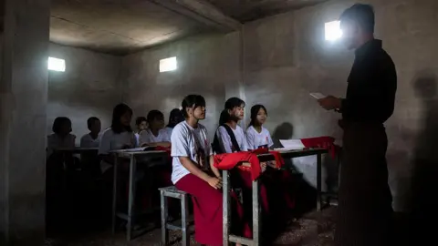 AFP via Getty Images This photo taken on August 15, 2025 show students studying in a classroom in a concrete bunker to protect against airstrikes at a village in the Sagaing region.