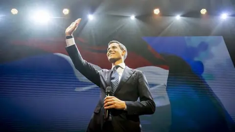 ROBIN UTRECHT/ANP/AFP The D66 stands on a podium and is greeted by supporters