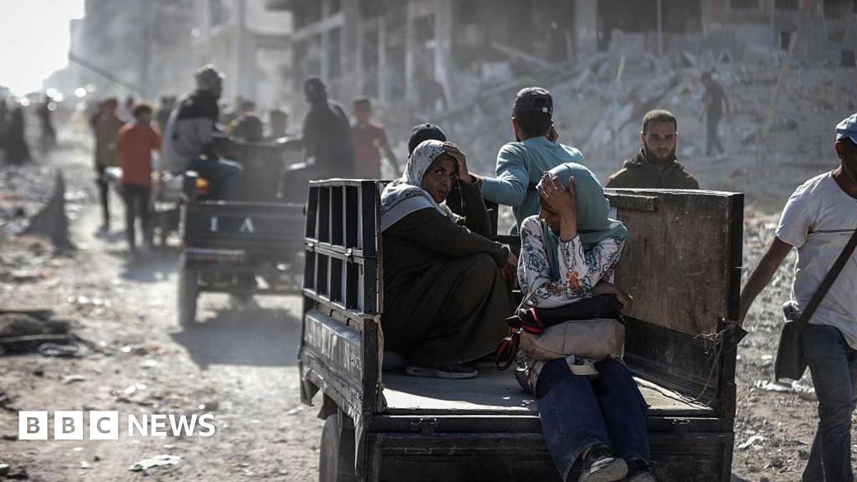 A woman on a cart in dusty landscape.