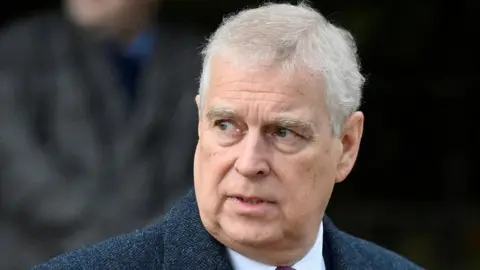 Reuters Prince Andrew is pictured from the shoulders up, looking to his right. 
