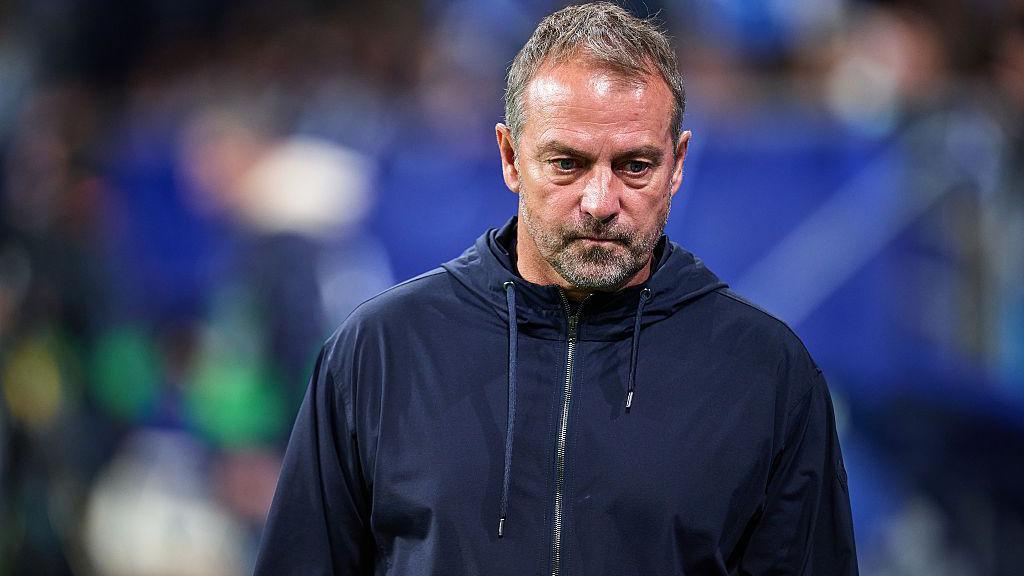 Barcelona head coach Hansi Flick in a hooded blue jacket at the La Liga match against Real Oviedo