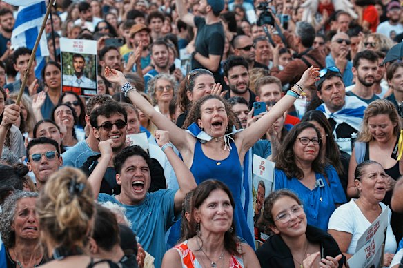 People react as they gather to watch a live broadcast of Israeli hostages released from Gaza at a plaza known as hostages square in Tel Aviv.