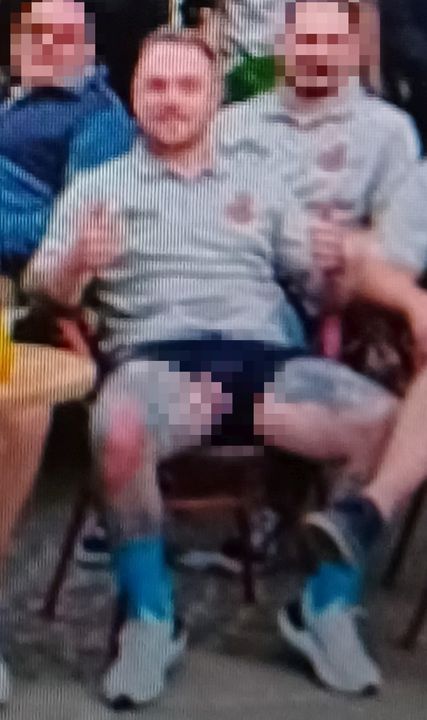 Philip Morrison poses with his genitals exposed in a team photo during their tour of Belgium last year