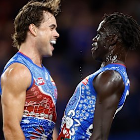 Lachie McNeil and Buku Khamis of the Bulldogs celebrate a goal against the Bombers back in May.