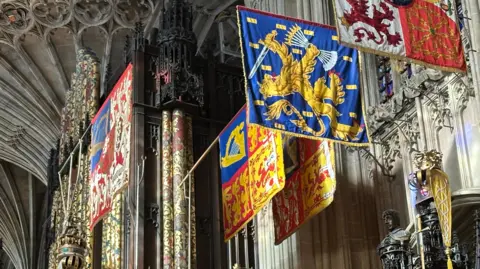 Banners hang near the ceiling of a chapel 