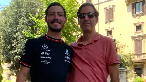 Family handout Ruby Chen stands with his son Itay Chen. Ruby wears a red polo shirt and his son wears a black t-shirt.