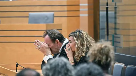 LIONEL BONAVENTURE/AFP Two lawyers clasp their hands to their faces in disbelief