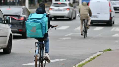 Getty A Deliveroo rider seen from the back on a bicycle