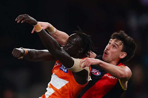 GWS defender Leek Aleer flies for a mark ahead if Essendon’s Liam McMahon in July.