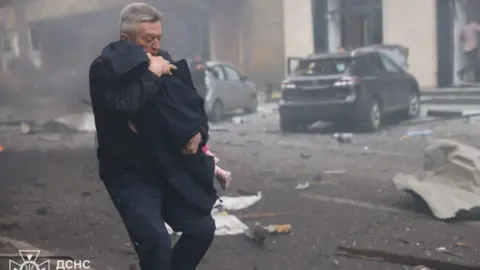 DSNS Ukraine A man runs from the scene of a blast in Kharkiv