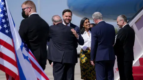 Reuters US Vice-President JD Vance (3rd L) and his wife Usha (3rd R) are greeted by the US ambassador to Israel, Mike Huckabee (2nd L), and Israeli Deputy Prime Minister Yariv Levin (R) after landing in Tel Aviv, Israel (21 October 2025) 