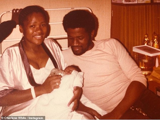 Charlene pictured as a baby with her late parents Dorrett and Denniston. She has previously spoken of the racism they faced after emigrating from the Caribbean