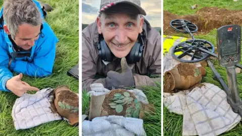 Minelab Detectorists lying on grass with Roman coins found in a roman jar in Wales