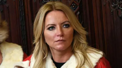 Getty Images Baroness Michelle Mone in the House of Lords wearing ceremonial robes. She has blonde hair.