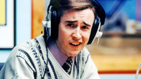 Alan Partridge broadcasting in the 1990s sitcom, I'm Alan Partridge