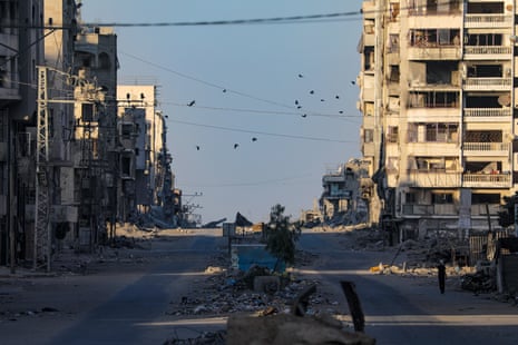 An empty Al Jalaa street as smoke rises following Israeli airstrike in Gaza City.