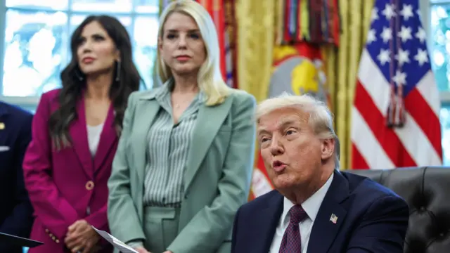 Homeland Security Secretary Kristi Noem (L) and Attorney General Pam Bondi (C) listen as President Donald Trump (R) speaks before signing a Presidential Memorandum in the Oval Office at the White House in Washington, DC, USA, 15 September 2025. US President Trump signs a Presidential Memorandum in the Oval Office