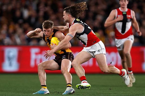 Dylan Moore is tackled by Jack Sinclair.