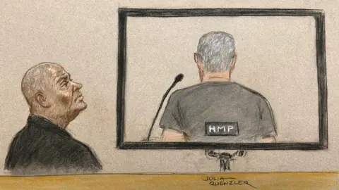 Julia Quenzler  Doreen Lawrence looking at the back of David Norris, who was appearing via video link during parole hearing at Royal Courts of Justice in central London