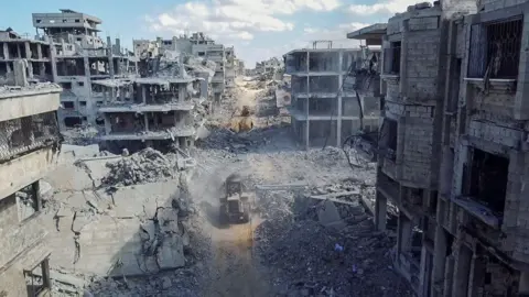 Reuters Heavy machinery seen amid the rubble of Gaza City