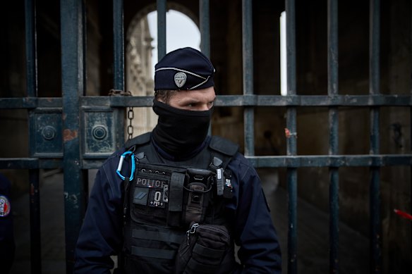 French police at the entrance to the Louvre following the heist.