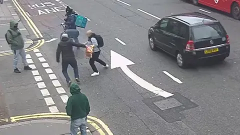CPS Still from undated handout CCTV footage issued by the Crown Prosecution Services (CPS) of Moussa Kadri (second left), attacking a man in Knightsbridge, on February 13, who was burning a copy of the Koran outside the Turkish consulate. Moussa Kadri was handed a 20-week prison sentence, suspended for 18 months at Southwark Crown Court on Tuesday. Issue date: Tuesday September 23, 2025.