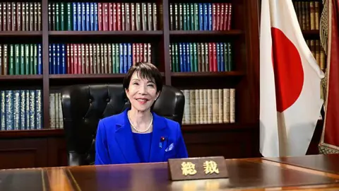 Getty Images Sanae Takaichi poses for a photo in the party leader's office after the LDP presidential election.