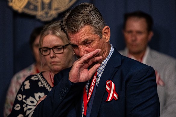 Paul Grimmer breaks down reading a prepared statement about the decision to name his sister’s alleged killer.