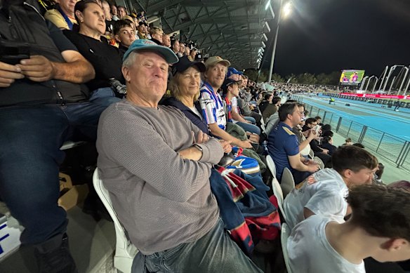 Peter watches the game with his wife Chrishna and son Carl.