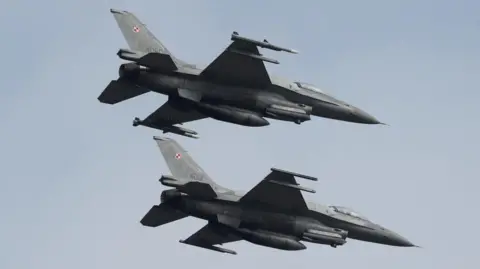 Reuters Two Polish F-16 fighter jets flying side by side