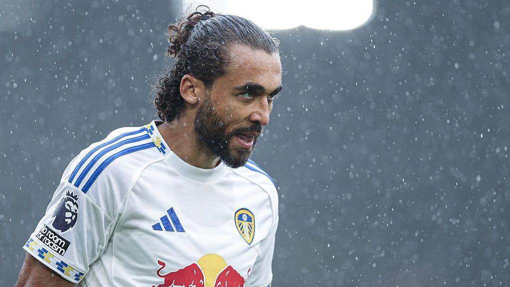 Dominic Calvert-Lewin stands in the rain