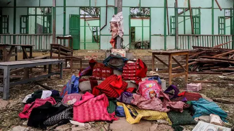 AFP via Getty Images Students' bags are kept in front of a school building damaged in a bombardment carried out by Myanmar's military at the Ohe Htein Twin village in Tabayin township, Sagaing Region, on May 12, 2025.